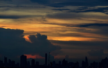 Sunset over a city with raincloud , Bangkok, Thailand
