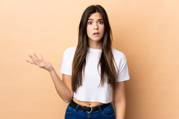 Teenager Brazilian girl over isolated background making doubts gesture