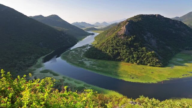 River envelops the horn peak in the ring. View of Canyon of Rijeka Crnojevica river, Skadar lake lacation. Impressive summer scene of Montenegro countryside. Full HD video (High Definition).