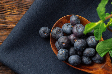 Bowl of fresh blueberry on kitchen table close up