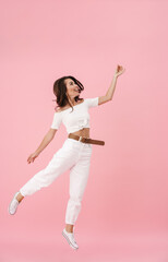 Image of delighted brunette woman dancing and laughing