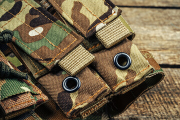Military body armor on wooden background close up
