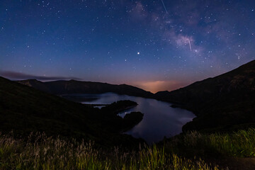Plakat Milky Way and shooting stars in the sky above Lagoa de Fogo (Fire Lagoon) in Ribeira Grande, São Miguel Island in Azores, Portugal.