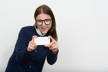Fototapeta premium Portrait of young beautiful businesswoman against white background