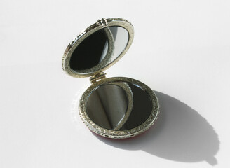 little pocket mirror isolated on white background