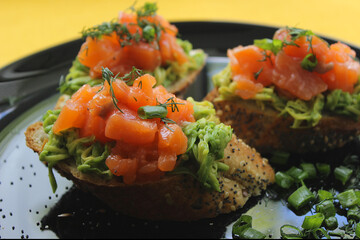 Sliced baguette with salmon and avocado slices