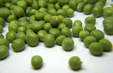 Fresh green peas on white background
