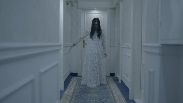 Psycho maniac girl walking hotel corridor, sharp knife in hand, chasing victim