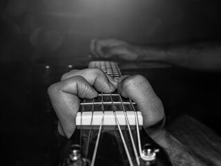 Naklejka premium A person Playing guitar in black and white