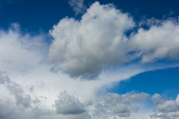 Beautiful blue sky background at daylight with white cumulus clouds.