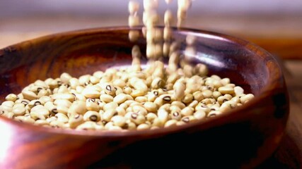 Black eye bean, black bean in wooden bowl,Black eyed peas close up on wooden bowl,selective focus without noise,black eyed bean or seed on wooden,