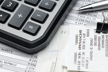 cash registers purchase receipt written on russian language, calculator and financial reports, analysis and accounting, various office items for bookkeeping