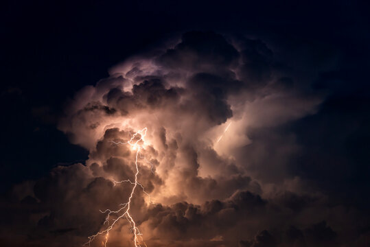 Dark cloud at  night with thunder bolt. Heavy storm bringing thunder, lightnings and rain in summer.