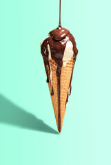 Vanilla ice cream cone with dripping chocolate. Ice cream with topping. Melted chocolate drip