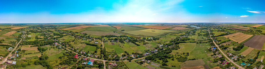 Fototapeta na wymiar the Porono-Pokrovsky farm not far from the village of Lvovskaya (South of Russia, Krasnodar Territory) - streets and houses of the classical village architecture of the Kuban - aerial panorama 