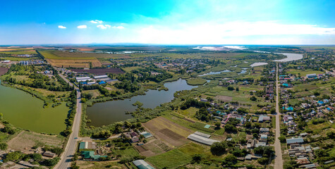 the village of Lvovskoe not far from the city of Krasnodar (South of Russia) - a pharmacy, streets and houses of the classic village architecture of the Kuban aerial small planet panorama on a summer 