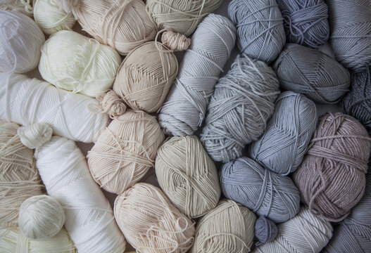 Vertical gradient from yarn of natural shades. White, beige, gray, black and cream colors.