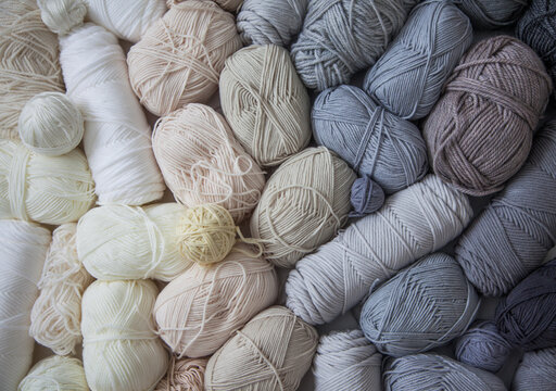 Vertical gradient from yarn of natural shades. White, beige, gray, black and cream colors.