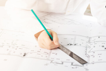 An architect draws a plan in an architectural Studio at a Desk