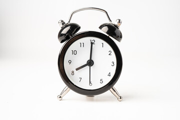 Black alarm clock isolated on white background.