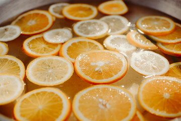 Orange lemonade in a large bowl. Summer concept.