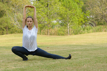 Young beautiful woman exercising at the park outdoors