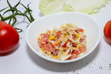 Fresh salad with salmon, tomatoes and Peking cabbage. Top view on white background