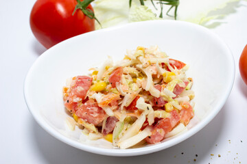 Fresh salad with salmon, tomatoes and Peking cabbage. Top view on white background