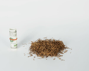 heap of tobacco with banknote lay on white background with copy space. concept for tobacco economy, tobacco trading.