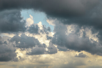 Naklejka na ściany i meble Storm cloud background before rain. Dramatic sky with huge black clouds. Selective focus.