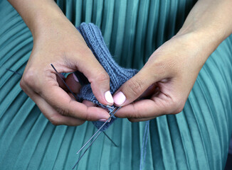 Close-up of hands knitting. Process of knitting.