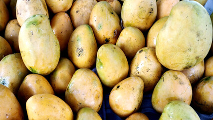 Heap of fresh ripe mangoes at market for sell