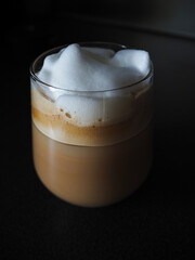 iced coffee with milk foam in the glass