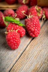 Freshly harvested raspberry on the rustic wooden background. Selective focus. Shallow depth of field. 
