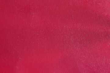 Red plastic background texture with gradient and shadows.