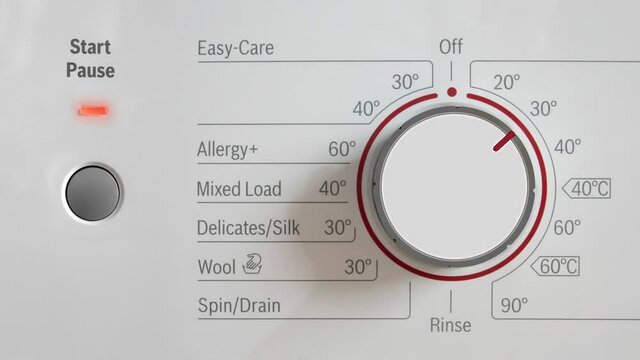 A Washing Machine Being Turned On At 30 Degrees To Save Energy And The Environment