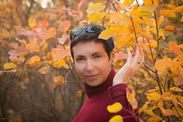 Picture of a middle-aged woman. Concept of emotions. Woman is happy to have rest outdoors after...