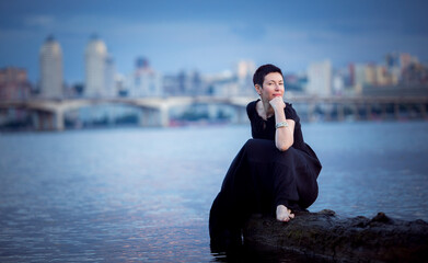 Picture of a middle-aged woman. Concept of emotions. Woman is happy to have rest outdoors after...