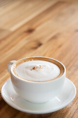 cappuccino coffee on wooden table with text space
