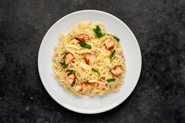 
pasta with salmon on a stone background