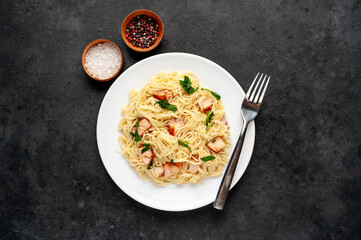 
pasta with salmon on a stone background