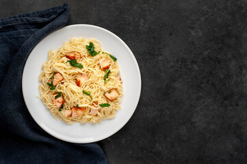 
salmon pasta on stone background with copy space for your text