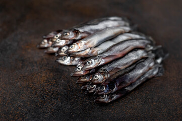 Fresh raw fish on a stone background. Selective focus 
with copy space for your text