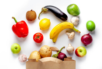 Paper bag with various products from store on white background. Healthy food.