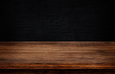 Side view of Empty wooden table top with dark concrete wall texture background for product showing.