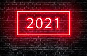 Text wording 2021 with neon lighting effect on black brick wall texture background for interior decoration.