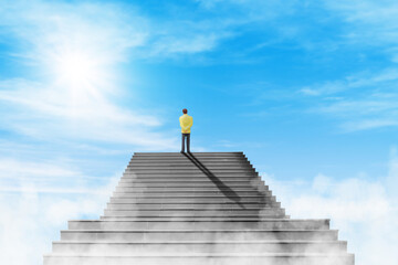 Business Vision and Success Concept : Businessman standing on the top of concrete staircase and looking forward to sky.