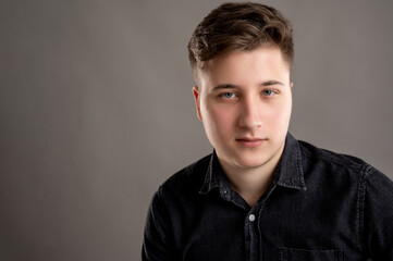 Head shot portrait of serious stylish attractive man dressed with a casual black shirt