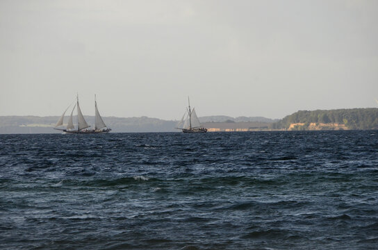 Sea in morning light, with an old sail ship beraking the horizon far away.