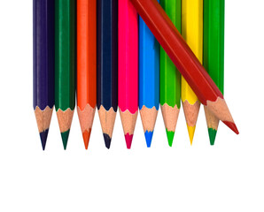 Red color wood pencil crayon placed on top of a row of different color wood pencil